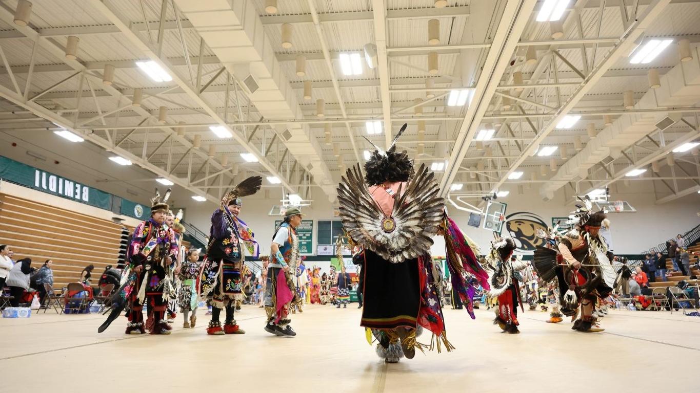 An Indian Pow Wow with many people in attence